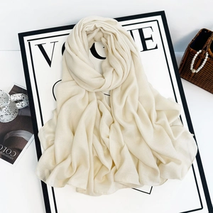 Detailed texture of a cream solid linen-like chiffon shawl with elegant drape and pearl finish