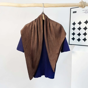 Detailed view of dark brown accordion pleat scarf draped on a wooden stand
