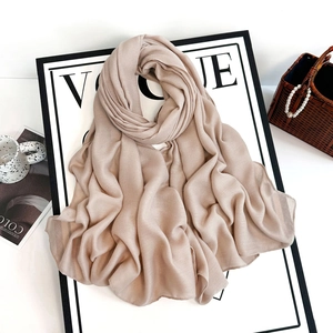 Close-up of light champagne chiffon shawl with delicate weave and elegant draping
