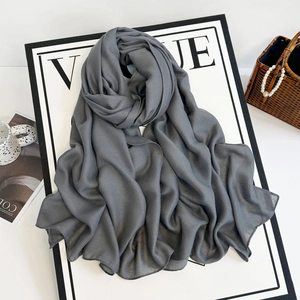 Detail shot of sheer dark grey chiffon headscarf with fine edge stitching on Vogue backdrop
