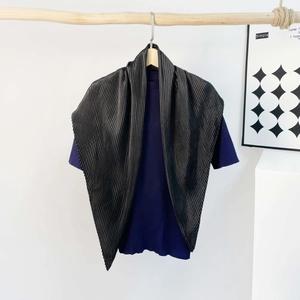 Detail showing the pleated texture of the silk scarf and ribbed knit shirt fabric