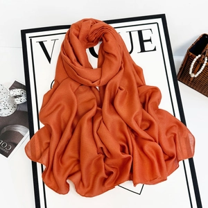 Close-up of caramel chiffon headscarf with soft pleated texture and elegant drape