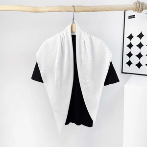 Detailed view of a white pleated silk-like satin scarf styled on a black t-shirt