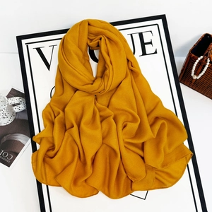 Detail of ginger yellow crinkle chiffon scarf with premium textured fabric and drape