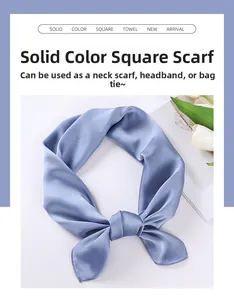 Detail of light blue satin scarf tied in a bow showing smooth silk-like texture