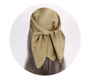 Detailed back view of a satin silk scarf tied as a headband on grey long hair