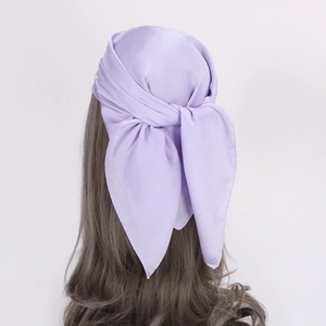 Detail view of light purple silk satin scarf tied on back of wavy hair with soft luster
