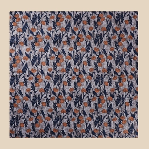 Flat lay detail of vintage square scarf featuring orange buds and blue fern patterns