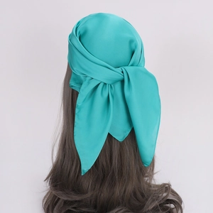 Glossy teal satin silk scarf for women tied as an elegant hair band with smooth texture