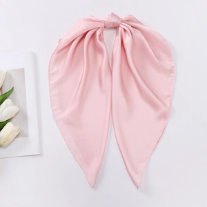 Detailed close-up of pink satin silk scarf showing smooth texture and elegant knotted bow