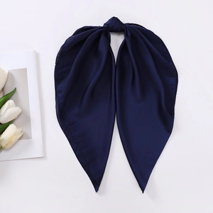 Detailed close-up of a knotted navy blue satin silk scarf with sharp corner design