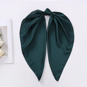 Close-up of elegant dark green satin bow scarf with silky texture and glossy finish