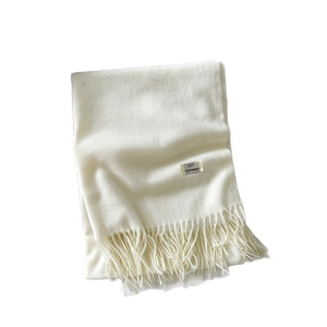 Classic cream cashmere feel scarf with fringe tassels and woven brand label