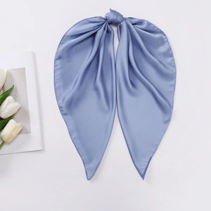 Detail of grey-blue satin silk scarf tied as a bow on minimalist white background