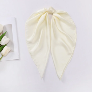 Macro shot of elegant cream white satin scarf with pearl luster and decorative knot
