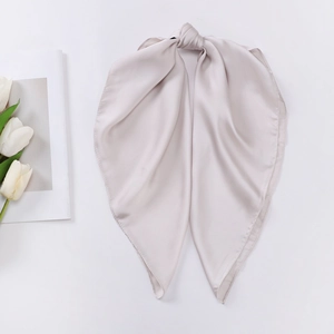 Detailed view of champagne satin silk scarf with elegant knotting and smooth texture