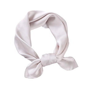 Champagne satin silk scarf tied in a neat flat knot on a clean white background