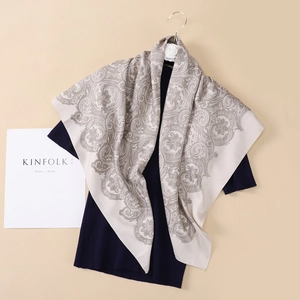 Elegant beige silk square scarf featuring grey paisley patterns and a soft glossy finish