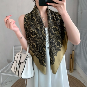 Detail of silk satin square scarf with vintage golden paisley patterns draped on model
