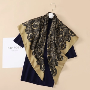 Close-up of paisley pattern silk scarf draped on a hanger with elegant lifestyle accessories