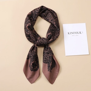 Detail view of brown paisley silk square scarf featuring elegant floral patterns
