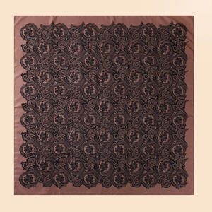 Detail of square satin scarf showing elegant black paisley pattern on bronze background
