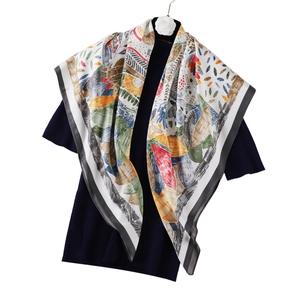 Détail de texture d'un foulard carré à imprimé feuilles colorées sur robe bleu foncé