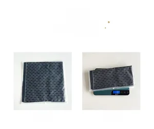 Detailed view of lightweight rose silk scarf in packaging showing 82g weight on scale