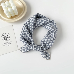 Detailed view of grey and blue geometric triangle pattern cotton scarf with fine stitching