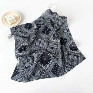 Detail showing folded cotton paisley square scarf with vintage black and white print