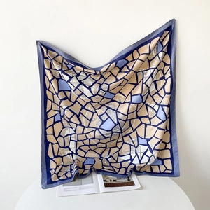 Detailed macro view of the colorful mosaic pattern on the lightweight twill silk scarf