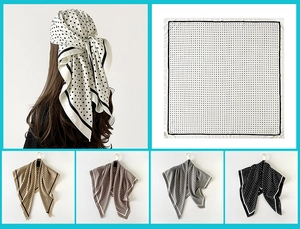 Detailed view of polka dot pattern silk-like square scarves in multiple color options