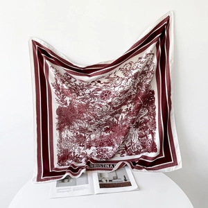 Detail of burgundy Toile de Jouy silk scarf with jungle print and striped border