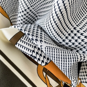 Classic houndstooth twill silk scarf in orange and black with soft elegant texture