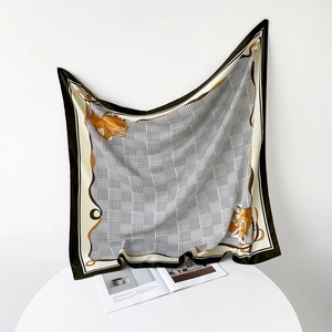 Detail of elegant square silk scarf with houndstooth pattern and floral print design
