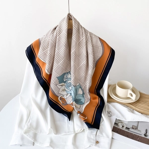 Detail of silk scarf showing houndstooth patterns and blue rose floral prints