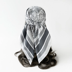 Close-up of Toile de Jouy floral pattern on premium silk scarf with striped edge