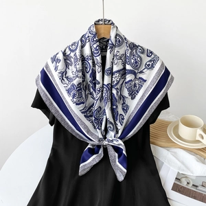 Classic white silk scarf with blue paisley pattern and elegant floral border design