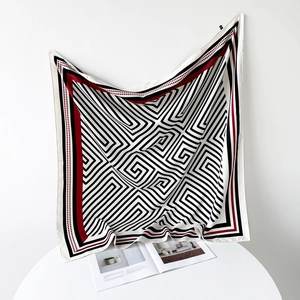 Detail of 90cm striped silk scarf showing monochromatic spiral pattern and smooth texture