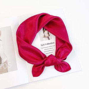 Detail of rose pink satin scarf knot with premium silky texture and glossy finish