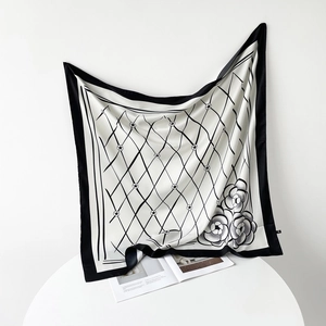 Detail of silk scarf showing vintage grid pattern and camellia flower print