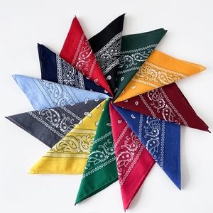 Flat lay of 12 colorful cotton paisley bandanas arranged in a radial star pattern