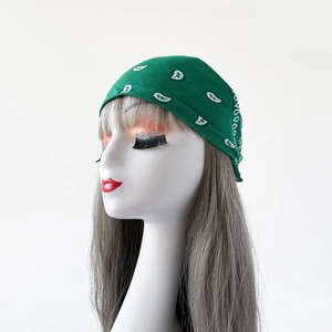 Detail of green paisley bandana on model showcasing the intricate white patterns and fabric