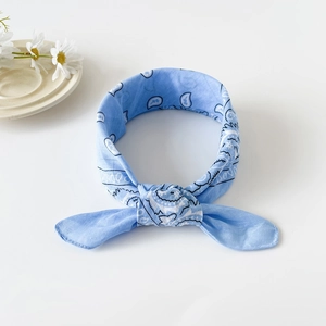 Detailed view of light blue cotton paisley bandana tied in a stylish knot design