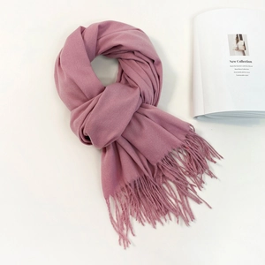 Elegant dusty pink cashmere-feel scarf for women with soft tassel details and warm texture