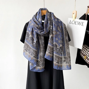 Close-up of vintage blue paisley cotton linen scarf with intricate floral border patterns