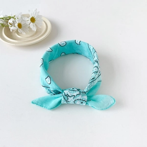 Detail of light blue cotton paisley bandana headband with a knot and floral props