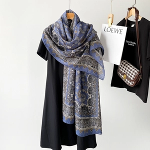 Detail of navy blue cotton linen scarf with paisley pattern draped on a black dress