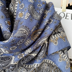 Close-up of dark blue paisley pashmina scarf fabric with elegant bohemian pattern detail