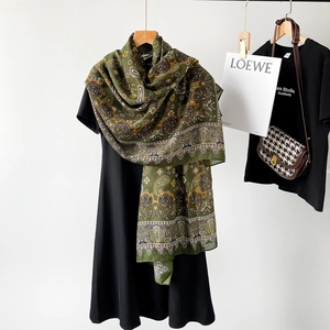 Detail view of cotton linen scarf with vintage green paisley pattern and fringe
